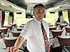 Henry Flosand viser stolt fram den nye Mercedes Tourismo-bussen, som han fikk levert for bare to uker siden.