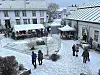 Julemarked i Berggårdstunet: Snøen lavet ned over boder og besøkende i et stemningsfullt tun.